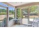 Bright sunroom with screened windows and a view of the backyard with mature trees and wood fence at 1337 Highfield Dr, Lawrenceville, GA 30043
