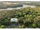 Overhead shot of the house surrounded by lush trees near a lake and the home address at 2062 Skyhawk at 2062 Skyhawk Ln, Acworth, GA 30102