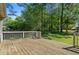 Wooden deck overlooking a large green lawn surrounded by mature trees at 2062 Skyhawk Ln, Acworth, GA 30102