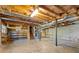 Spacious unfinished basement with open ceiling, concrete floor, shelving, and exposed support beams at 2062 Skyhawk Ln, Acworth, GA 30102