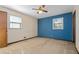 Bedroom featuring neutral walls, ceiling fan, and bright blue accent wall at 2062 Skyhawk Ln, Acworth, GA 30102