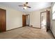 Bedroom with multiple entryways and ceiling fan, featuring neutral carpet and walls at 2062 Skyhawk Ln, Acworth, GA 30102