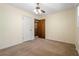 Bedroom with tan carpet, light walls, ceiling fan, and white painted door on the left at 2062 Skyhawk Ln, Acworth, GA 30102