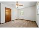 Bedroom featuring ceiling fan and neutral carpet with a large closet at 2062 Skyhawk Ln, Acworth, GA 30102