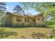 Charming home featuring a well-maintained lawn, inviting entrance, and classic architectural details under a clear blue sky at 2062 Skyhawk Ln, Acworth, GA 30102