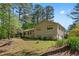 Traditional house with ample yard space, featuring a cozy front porch and driveway on a sunny day at 2062 Skyhawk Ln, Acworth, GA 30102