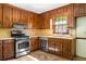 Classic kitchen featuring wood cabinets, stainless steel appliances, and a sunny window at 2062 Skyhawk Ln, Acworth, GA 30102
