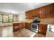 Eat-in kitchen with wood cabinets, a breakfast bar, and stainless steel appliances for cooking convenience at 2062 Skyhawk Ln, Acworth, GA 30102