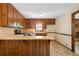 Functional kitchen with wooden cabinets and a breakfast bar, combining classic charm with modern convenience at 2062 Skyhawk Ln, Acworth, GA 30102