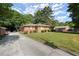 The front exterior of this home is surrounded by a well-manicured lawn and mature trees at 2844 Whispering Hills Dr, Chamblee, GA 30341