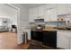 Cozy kitchen with white cabinets and view to the living area at 2844 Whispering Hills Dr, Chamblee, GA 30341