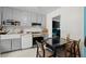 Functional kitchen features gray cabinets, modern appliances, and an adjacent dining area at 2844 Whispering Hills Dr, Chamblee, GA 30341