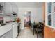 Bright kitchen with white appliances, marble countertops, and an adjacent dining area at 2844 Whispering Hills Dr, Chamblee, GA 30341