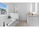 Bright bathroom featuring a tub and a white vanity with quartz countertop at 3291 Pepperpike Ct, Loganville, GA 30052