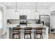 Modern kitchen featuring stainless steel appliances, white cabinetry, and a breakfast bar at 3291 Pepperpike Ct, Loganville, GA 30052