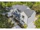 Aerial view of a modern farmhouse with a well-manicured lawn, stone pathway, and a spacious driveway at 4785 Longchamps Dr, Sandy Springs, GA 30319