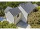 Aerial view of the side and rear of a modern farmhouse showcasing the garage and spacious yard at 4785 Longchamps Dr, Sandy Springs, GA 30319