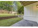 Beautiful backyard with patio area, a brick retaining wall, green grass and privacy fence at 4785 Longchamps Dr, Sandy Springs, GA 30319