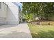 The property boasts a well-manicured backyard with lush greenery and a pristine white exterior at 4785 Longchamps Dr, Sandy Springs, GA 30319