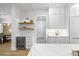 Wet bar features wine refrigerator, white cabinets, floating shelves, and hardwood floors at 4785 Longchamps Dr, Sandy Springs, GA 30319