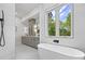 Bright bathroom with soaking tub, double vanity, and outside view at 4785 Longchamps Dr, Sandy Springs, GA 30319