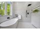 Stylish bathroom features a soaking tub and bright natural light at 4785 Longchamps Dr, Sandy Springs, GA 30319