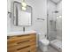 Modern bathroom with a wood vanity, sleek fixtures, and a glass-enclosed shower at 4785 Longchamps Dr, Sandy Springs, GA 30319
