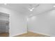 Bright bedroom featuring a ceiling fan, light hardwood floors, and a walk-in closet with built-in shelving at 4785 Longchamps Dr, Sandy Springs, GA 30319