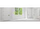 Bright, open bedroom with white walls and trim, featuring large window and multiple doors at 4785 Longchamps Dr, Sandy Springs, GA 30319