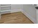 Walk-in closet with custom built-in shelving and light hardwood flooring at 4785 Longchamps Dr, Sandy Springs, GA 30319