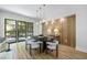 Stylish dining room boasting a unique wood accent wall and modern lighting at 4785 Longchamps Dr, Sandy Springs, GA 30319