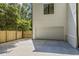 A lengthy concrete driveway leads to a two-car garage and landscaped yard, perfect for Gathering living at 4785 Longchamps Dr, Sandy Springs, GA 30319