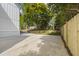 Long driveway next to manicured lawn and wooden fence leading to a view of lush trees at 4785 Longchamps Dr, Sandy Springs, GA 30319