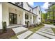 Beautiful exterior with white painted brick, black accents, and a stepping stone walkway at 4785 Longchamps Dr, Sandy Springs, GA 30319