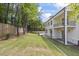 The backyard showcases a newly installed lawn, a charming balcony, and an elegant, white exterior at 4785 Longchamps Dr, Sandy Springs, GA 30319
