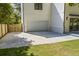 The side of the home features an expansive driveway, a two-car garage, and a manicured lawn at 4785 Longchamps Dr, Sandy Springs, GA 30319