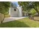 Side exterior view of house featuring a garage, long driveway, and a manicured lawn and fence at 4785 Longchamps Dr, Sandy Springs, GA 30319