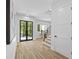 Light-filled foyer showcases hardwood floors, staircase, and access to multiple rooms at 4785 Longchamps Dr, Sandy Springs, GA 30319