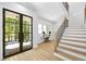 Bright foyer features hardwood floors, staircase, and stylish console table at 4785 Longchamps Dr, Sandy Springs, GA 30319