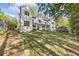Charming two-story home boasting white siding, black windows, and a beautifully landscaped front lawn at 4785 Longchamps Dr, Sandy Springs, GA 30319