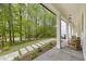 Spacious front porch with stone floors, wooded view, and comfortable seating area at 4785 Longchamps Dr, Sandy Springs, GA 30319