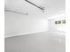 Clean garage with epoxy flooring, ample space, and natural light, perfect for storage and vehicles at 4785 Longchamps Dr, Sandy Springs, GA 30319
