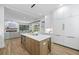 Bright, modern kitchen features a large center island with seating and stainless steel appliances at 4785 Longchamps Dr, Sandy Springs, GA 30319