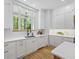 Bright kitchen with white cabinets, quartz countertops, undermount sink, and stainless steel appliances at 4785 Longchamps Dr, Sandy Springs, GA 30319