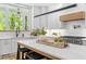 Modern kitchen featuring white cabinets, quartz countertops, stainless steel appliances, island, and black accents at 4785 Longchamps Dr, Sandy Springs, GA 30319