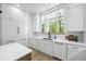 Bright kitchen featuring white cabinetry, stainless steel appliances, and quartz countertops at 4785 Longchamps Dr, Sandy Springs, GA 30319