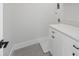 Bright laundry room featuring white cabinets, a countertop, and gray tile flooring at 4785 Longchamps Dr, Sandy Springs, GA 30319