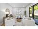 Bright living room featuring four chairs, contemporary art and a sliding glass door to the backyard at 4785 Longchamps Dr, Sandy Springs, GA 30319