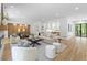Open concept living room features modern fireplace, dining area, and an abundance of natural light at 4785 Longchamps Dr, Sandy Springs, GA 30319