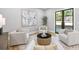 Bright living room featuring four chairs, contemporary art and a sliding glass door to the backyard at 4785 Longchamps Dr, Sandy Springs, GA 30319